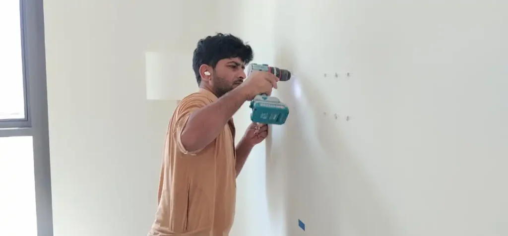 handyman doing holes to hang tv