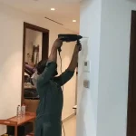 Handyman in Downtown Dubai 1 Handyman drilling in wall to hang a frame